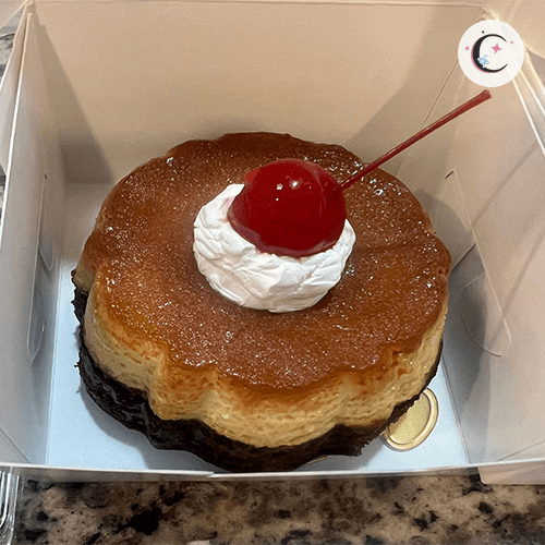 Chocoflan, a chocolate cake topped with flan and decorated with whipped cream and a cherry.