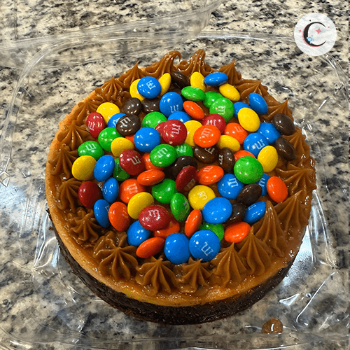 Large Chocoflan, a chocolate cake topped with flan, decorated with M&M and dulce de leche.