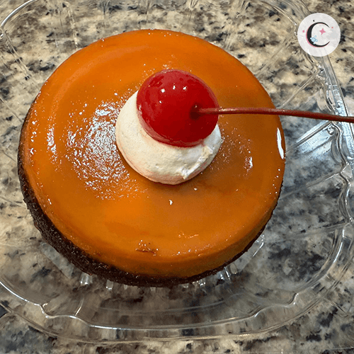 Chocoflan, a chocolate cake topped with flan and decorated with whipped cream and a cherry.