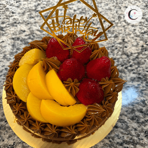 Large Chocoflan, a chocolate cake topped with flan, decorated with fresh fruits and dulce de leche.