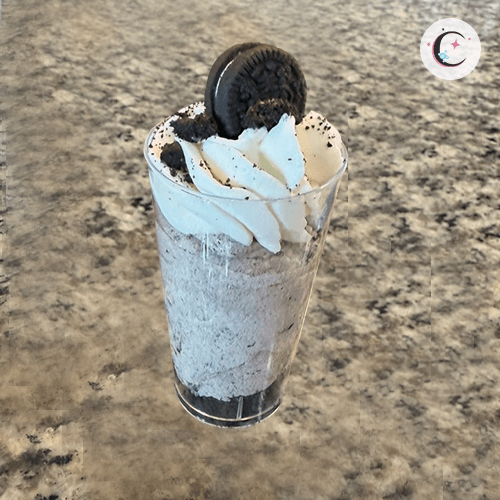 Oreo cream dessert with an Oreo cookie crust, topped with whipped cream and Oreo pieces.