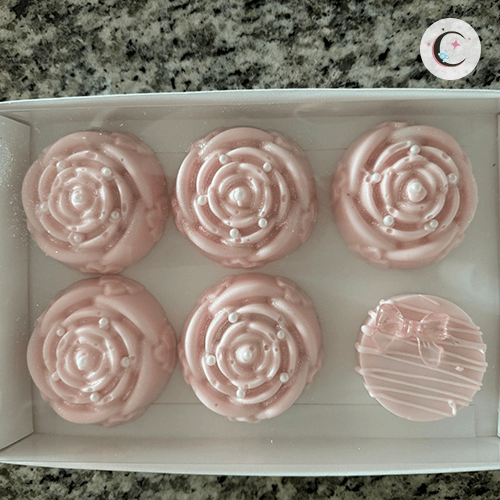 Chocolate cupcakes decorated with pink chocolate.