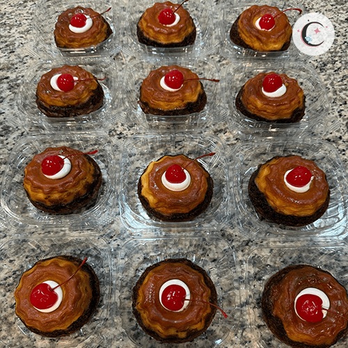 Mini Chocoflan, chocolate cake topped with flan, decorated with whipped cream and a cherry.