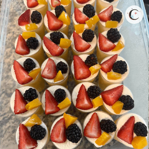 Passion fruit mousse, topped with whipped cream and fresh fruits.