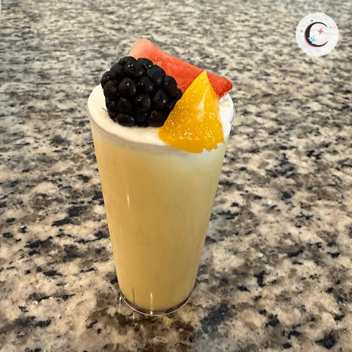Passion fruit mousse, topped with whipped cream and fresh fruits.